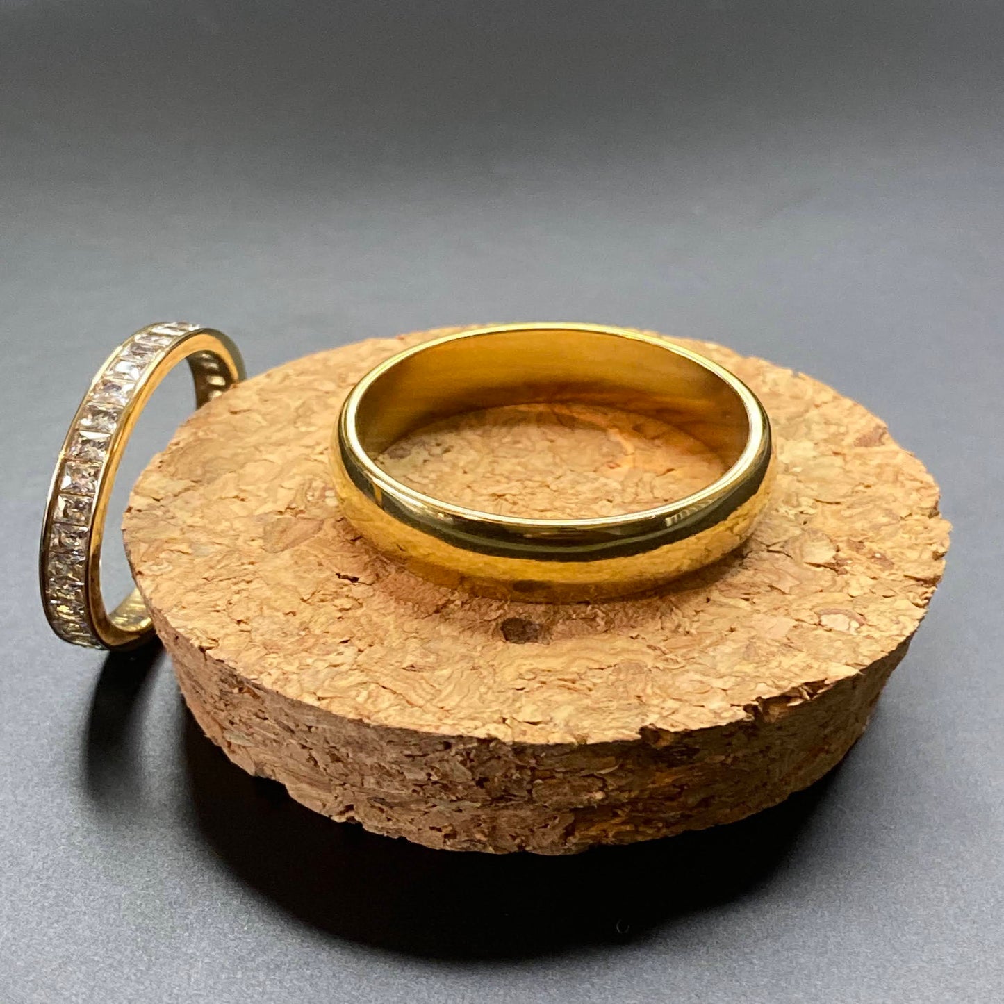 2 ring set includes a thick, solid band & a channel-set thin band with square zircon stones. Made from high-quality stainless steel, these rings are designed for plus-sized fingers & plated in 18k gold