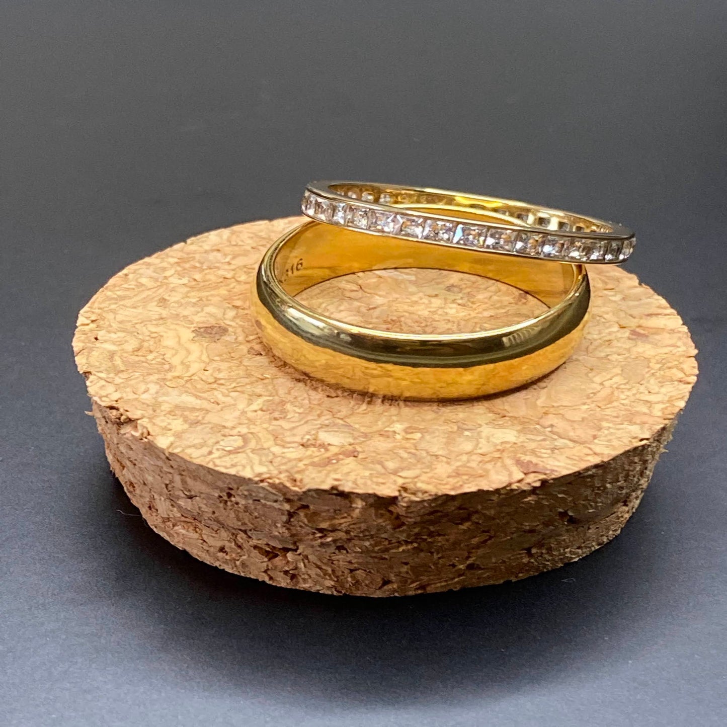 2 ring set includes a thick, solid band & a channel-set thin band with square zircon stones. Made from high-quality stainless steel, these rings are designed for plus-sized fingers & plated in 18k gold