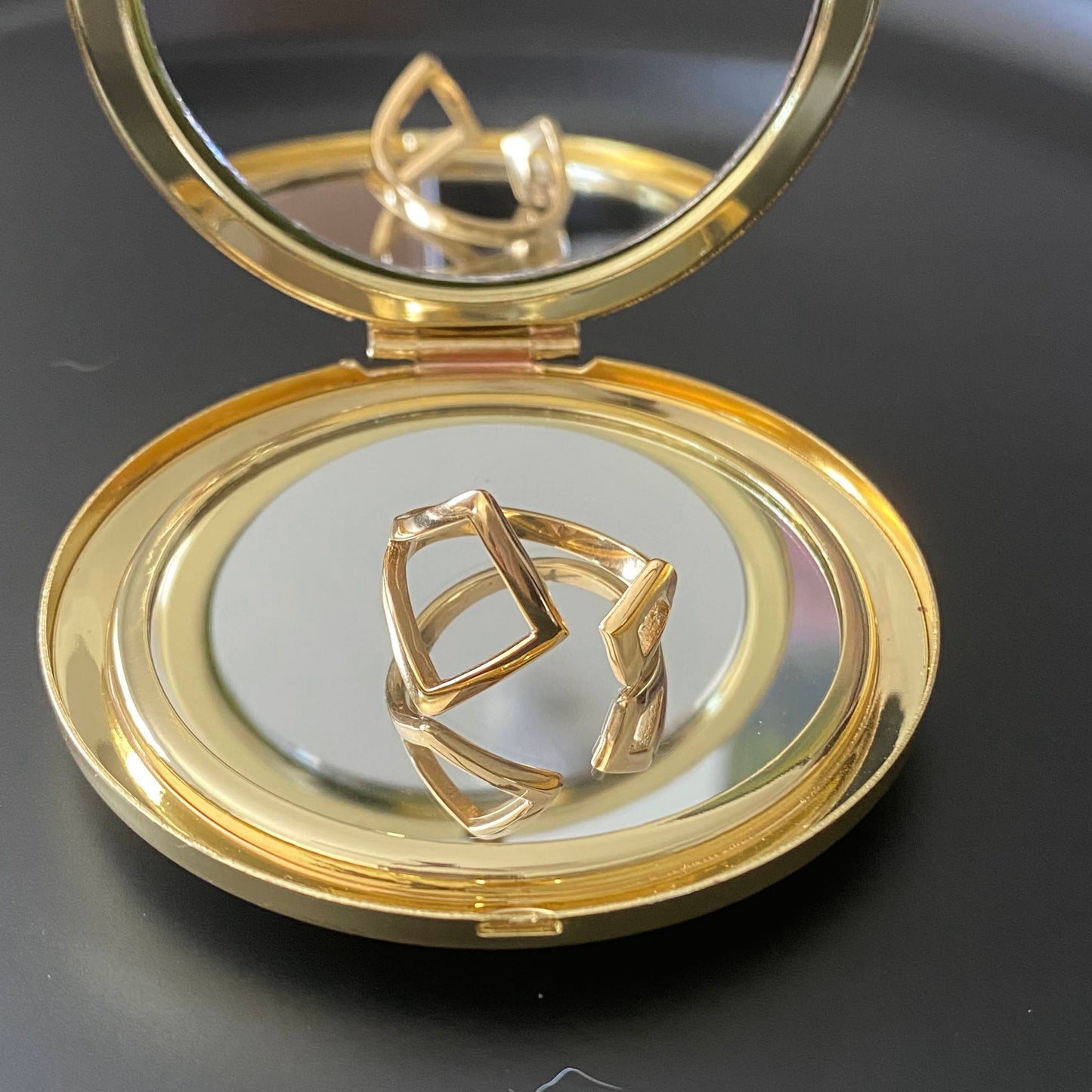 Plus-sized open design ring with two asymmetrical diamond-shaped openings. 18K gold plated stainless steel.