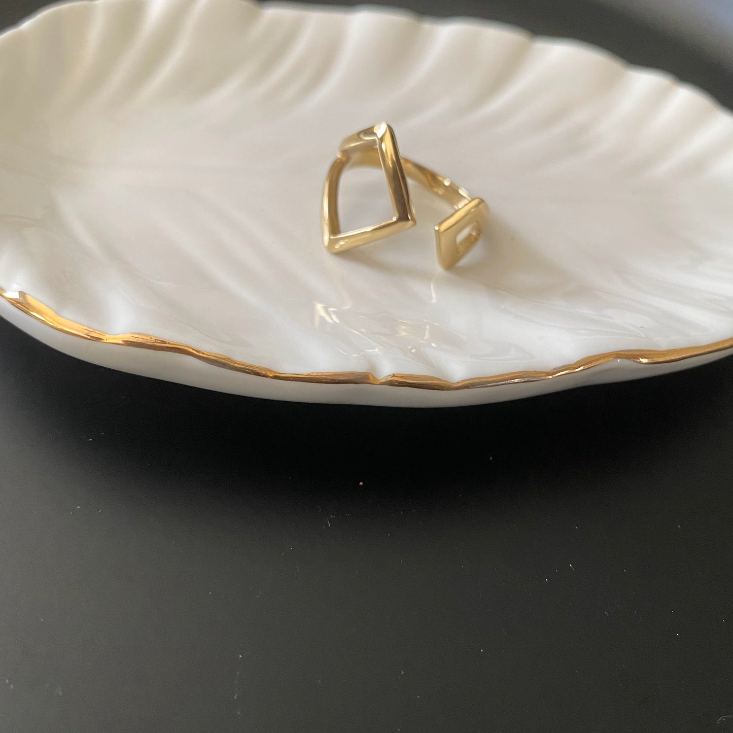Plus-sized open design ring with two asymmetrical diamond-shaped openings. 18K gold plated stainless steel.