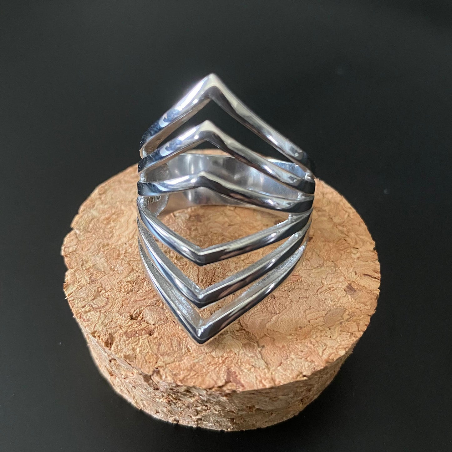 Polished multi-v shaped stainless steel ring for plus sizes.